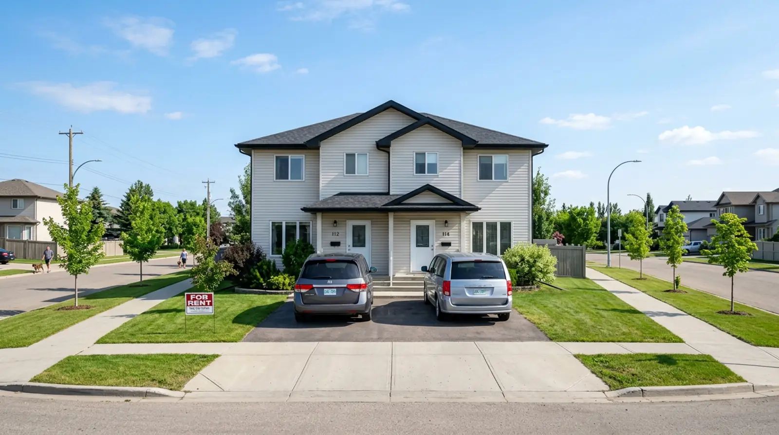 Martensville side by side duplex with two driveways, landscaped lawns, and a For Rent sign staked at the property line.